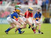 24 June 2012; Molly Ni Riain, G.S. Carrig Uí Laighin, Cork, in action against Aoife Ryan, Donaskeagh NS, left, and Daron Creamer, Portroe NS, Tipperary. Primary Go Games during Cork v Tipperary - Munster GAA Hurling Senior Championship Semi-Final, Páirc Uí Chaoimh, Cork. Picture credit: Stephen McCarthy / SPORTSFILE