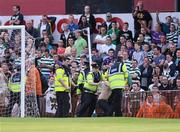 29 June 2012; Members of An Garda Síochána tussle with a supporter after Peter McMahon, Bohemians, had scored his side's first goal. Airtricity League Premier Division, Bohemians v Shamrock Rovers, Dalymount Park, Dublin. Picture credit: David Maher / SPORTSFILE