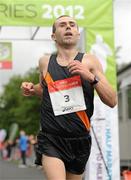 30 June 2012; Gary O'Hanlon, Clonliffe Harriers A.C., Co. Dublin, crosses the line to win the Irish Runner 5 Mile Road Race. Phoenix Park, Dublin. Picture credit: Tomas Greally / SPORTSFILE