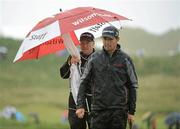 30 June 2012; Padraig Harrington with his caddy Ronan Flood on the first green during the 2012 Irish Open Golf Championship. Royal Portrush, Portrush, Co. Antrim. Picture credit: Matt Browne / SPORTSFILE