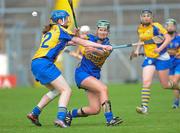 30 June 2012; Caoimhe Maher, Tipperary, gets a hand pass away despite the efforts of Clare's Maire McGrath. All-Ireland Senior Camogie Championship Round Two, Tipperary v Clare, Semple Stadium, Thurles, Co. Tipperary. Picture credit: Ray Lohan / SPORTSFILE
