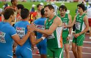 30 June 2012; Ireland's David Gillick and team-mates Brian Murphy and Tim Crowe congratulate the Italian team after the semi-final of the Men's 4x400m. European Athletics Championship, Day 4, Olympic Stadium, Helsinki, Finland. Picture credit: Brendan Moran / SPORTSFILE