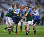 17 September 2017; James Cranny, Bennekerry National School, Bennekerry, Co. Carlow, representing Dublin, Ruairí McCullagh, right,  St. Teresa's P.S., Loughmacrory, Omagh, Co. Tyrone, representing Dublin, and in action against Martin Kirk, left, St. Finloughs PS, Limavady, Co. Derry, representing Mayo, and Ryan Byrne, Cloontuskert NS, Cloontuskert, Lanesboro, Co. Roscommon, representing Mayo, during the INTO Cumann na mBunscol GAA Respect Exhibition Go Games at Dublin v Mayo GAA Football All-Ireland Senior Championship Final at Croke Park in Dublin. Photo by Ray McManus/Sportsfile