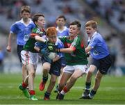 17 September 2017; James Cranny, Bennekerry National School, Bennekerry, Co. Carlow, representing Dublin, Ruairí McCullagh, right,  St. Teresa's P.S., Loughmacrory, Omagh, Co. Tyrone, representing Dublin, and in action against Martin Kirk, left, St. Finloughs PS, Limavady, Co. Derry, representing Mayo, and Ryan Byrne, Cloontuskert NS, Cloontuskert, Lanesboro, Co. Roscommon, representing Mayo, during the INTO Cumann na mBunscol GAA Respect Exhibition Go Games at Dublin v Mayo GAA Football All-Ireland Senior Championship Final at Croke Park in Dublin. Photo by Ray McManus/Sportsfile