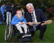 22 September 2017; Nathan Kiely, age 6, from Blanchardstown, learns more about hurling from Uachtarán Chumann Lúthchleas Gael Aogán Ó Fearghail at the GAA Fun & Run Launch at Culture Night at Trinity College Cricket Ground in Dublin. GAA Fun & Run is a specially designed programme which focuses upon the integration and inclusion of people with disabilities in Gaelic games, while also giving participants the opportunity to take part in 60 minutes of moderate to vigorous activity. Photo by Cody Glenn/Sportsfile