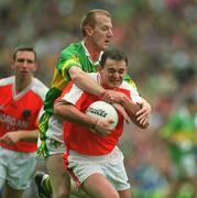 22 September 2002; Aidan O'Rourke of Armagh is tackled by Liam Hassett of Kerry during the GAA Football All-Ireland Senior Championship Final match between Armagh and Kerry at Croke Park in Dublin. Photo by Brendan Moran/Sportsfile