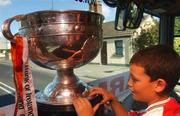 23 September 2002; Ross Kernan, son of Armagh manager Joe, keeps an eye on the Sam Maguire cup on their journey back to Armagh for the teams homecoming after winning the All-Ireland Senior Football Championship. Photo by Damien Eagers/Sportsfile