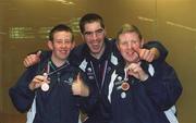 30 September 2002; Ireland's Special Olympics Basketball players, from left, Andrew Connolly, Michael Larkin and James O'Leary, from Wexford, who competed at the European Basketball Tournament in Moscow, pictured with their medals, on their arrival home at Dublin Airport in Dublin. Photo by Aoife Rice/Sportsfile