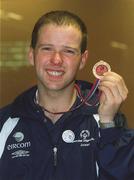 30 September 2002; Ireland's Special Olympics Basketball player Noel Murphy, from Wexford, who competed at the European Basketball Tournament in Moscow, pictured with his medal, on his arrival home at Dublin Airport in Dublin. Photo by Aoife Rice/Sportsfile