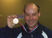 30 September 2002; Ireland's Special Olympics Basketball Captain, Fintan Broaders, from Wexford, who competed at the European Basketball Tournament in Moscow, pictured with his medal, on their arrival home at Dublin Airport in Dublin. Photo by Aoife Rice/Sportsfile
