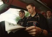 23 September 2002; John McEntee, left, and Paul McGrane read Mondays newspapers on their journey back to Armagh for the teams homecoming after winning the All-Ireland Senior Football Championship. Photo by Damien Eagers/Sportsfile