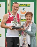 8 July 2012; Paul Hession, Athenry AC, Galway, is presented with the Paddy Larkin memorial trophy by Paula O'Doherty, daughter of Paddy Larkin, after winning the Men's 100m. Woodie’s DIY Senior Track and Field Championships of Ireland, Morton Stadium, Santry, Dublin. Picture credit: Brendan Moran / SPORTSFILE