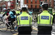 24 September 2017; Cllr. Janice Boylan was on hand in Smithfield, to officially start the biggest cycling event of its kind to take place in Dublin. The Great Dublin Bike Ride is an initiative from Sport Ireland who work in conjunction with Dublin City Council, Healthy Ireland, Fingal County Council and Cycling Ireland.The Great Dublin Bike Ride was a flagship event in Ireland for the European Week of Sport (23 - 30 September) and encourages everyone to #BeActive. The Gardaí, Luas, Dublin Bus and Civil Defence worked hard with the various city and county councils to ensure the safety and enjoyment of participants on the day. Pictured are members of An Garda Síochána as they watch riders at the start of The Great Dublin Bike Ride 2017, Aran Quays, in Dublin. Photo by Seb Daly/Sportsfile