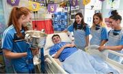25 September 2017; Rory Whelan, age 14, from Fethard-on-Sea, Co Wexford, meets Dublin Senior Ladies Footballers, from left, Lauren Magee, Lyndsey Davey, Rebecca McDonnell, and Hannah O'Neill, with the Brendan Martin Cup in attendance during the All-Ireland Senior Ladies Football Champions visit to Temple Street Children's Hospital at Temple Street Children’s Hospital, in Dublin. Photo by Cody Glenn/Sportsfile