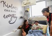 25 September 2017; Tristan Gannon, age 7, from Skerries, Co Dublin, reads with Mayo senior ladies footballers Doireann Hughes, left, and Martha Carter during the All-Ireland Senior Ladies Football Champions visit to Temple Street Children's Hospital at Temple Street Children’s Hospital, in Dublin. Photo by Cody Glenn/Sportsfile