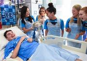 25 September 2017; Rory Whelan, age 14, from Fethard-on-Sea, Co Wexford, celebrates with the Brendan Martin Cup and Dublin senior ladies footballers, from left, Lyndsey Davey, Rebecca McDonnell, Hannah O'Neill, Emily Flanagan, and Lauren Magee during the All-Ireland Senior Ladies Football Champions visit to Temple Street Children's Hospital at Temple Street Children’s Hospital, in Dublin. Photo by Cody Glenn/Sportsfile