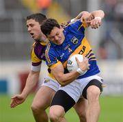 14 July 2012; Ciaran McDonald, Tipperary, in action against Ciaran Lyng, Wexford. GAA Football All-Ireland Senior Championship Qualifier, Round 2, Tipperary v Wexford, Semple Stadium, Thurles, Co. Tipperary. Picture credit: Stephen McCarthy / SPORTSFILE