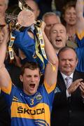 15 July 2012; Uachtarán Chumann Lúthchleas Gael Liam Ó Néill looks on as the Tipperary captain Paul Curran lifts the cup. Munster GAA Hurling Senior Championship Final, Waterford v Tipperary, Pairc Ui Chaoimh, Cork. Picture credit: Ray McManus / SPORTSFILE