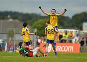 15 July 2012; A dejected Shane Hennelly, left, Mayo, as Roscommon captain Enda Smith is lifted up by team-mate Kieran Kilcline, as they celebrate their victory after the game. Connacht GAA Football Minor Championship Final, Mayo v Roscommon, Dr. Hyde Park, Roscommon. Picture credit: Barry Cregg / SPORTSFILE