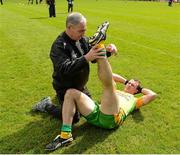 30 June 2012; Neil McGee, Donegal, stretches under the supervision of  Donal Reid, former All Ireland winning Donegal player 1992 and Team Physiotherapist. Ulster GAA Football Senior Championship Semi-Final, Tyrone v Donegal, St Tiernach's Park, Clones, Co. Monaghan. Picture credit: Oliver McVeigh / SPORTSFILE