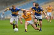 21 July 2012; Tony Scullion, Antrim, in action against Brian Fox, left, and Robbie Kiely, right, Tipperary. GAA Football All-Ireland Senior Championship Qualifier, Round 3, Tipperary v Antrim, Semple Stadium, Thurles, Co. Tipperary. Picture credit: Barry Cregg / SPORTSFILE