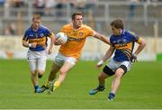 21 July 2012; Mark Sweeney, Antrim, in action against Brian Fox, left, and Robbie Kiely, right, Tipperary. GAA Football All-Ireland Senior Championship Qualifier, Round 3, Tipperary v Antrim, Semple Stadium, Thurles, Co. Tipperary. Picture credit: Barry Cregg / SPORTSFILE