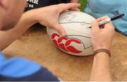 25 July 2012; Leinster's Fionn Carr autographs a ball during the Donnybrook VW Leinster Rugby Summer Camp. Donnybrook Stadium, Donnybrook, Dublin. Picture credit: Pat Murphy / SPORTSFILE