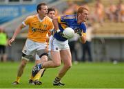 21 July 2012; George Hannigan, Tipperary, in action against Michael McCann, Antrim. GAA Football All-Ireland Senior Championship Qualifier, Round 3, Tipperary v Antrim, Semple Stadium, Thurles, Co. Tipperary. Picture Credit: Barry Cregg / SPORTSFILE