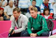 31 July 2012; Team Ireland coaches Daniel Magee, right, and Jim Laugesen watch on as Chloe Magee competes in the women's singles group play stage against France's Hongyan Pi. London 2012 Olympic Games, Badminton, Wembley Arena, Wembley, London, England. Picture credit: Stephen McCarthy / SPORTSFILE