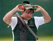 5 August 2012; Ireland's Derek Burnett removes his ear muffs during the men's trap shooting qualification. London 2012 Olympic Games, Shooting, The Royal Artillery Barracks, Greenwich, London, England. Picture credit: Stephen McCarthy / SPORTSFILE