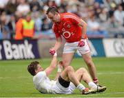 5 August 2012; A dejected Emmet Bolton, Kildare, is helped to his feet by Paul Kerrigan, Cork, after the game. GAA Football All-Ireland Senior Championship Quarter-Final, Cork v Kildare, Croke Park, Dublin. Picture credit: Dáire Brennan / SPORTSFILE