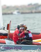 6 August 2012; Ireland's Annalise Murphy is consoled by coach Rory Fitzpatrick following the women's laser radial class medal race. London 2012 Olympic Games, Sailing, Weymouth & Portland National Sailing Academy, Portland, Dorset, England. Picture credit: David Branigan / SPORTSFILE