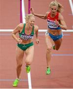 7 August 2012; Ireland's Derval O’Rourke crosses the line ahead of Yuliya Kondakova, Russia, in their semi-final of the women's 100m hurdles where she finished 5th but did not qualify for the final. London 2012 Olympic Games, Athletics, Olympic Stadium, Olympic Park, Stratford, London, England. Picture credit: Brendan Moran / SPORTSFILE