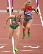 7 August 2012; Ireland's Derval O’Rourke crosses the line ahead of Yuliya Kondakova, Russia, in their semi-final of the women's 100m hurdles where she finished 5th but did not qualify for the final. London 2012 Olympic Games, Athletics, Olympic Stadium, Olympic Park, Stratford, London, England. Picture credit: Brendan Moran / SPORTSFILE
