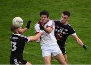 15 October 2017; Karl McKaigue of Slaughtneil in action against Jerome Johnstone, left, and Dylan Ward of Kilcoo during the AIB Ulster GAA Football Senior Club Championship First Round match between Kilcoo and Slaughtneil at Páirc Esler in Down. Photo by Seb Daly/Sportsfile