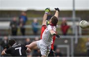 15 October 2017; Patsy Bradley of Slaughtneil out jumps goalkeeper Stephen Kane of Kilcoo to score his side's goal during the AIB Ulster GAA Football Senior Club Championship First Round match between Kilcoo and Slaughtneil at Páirc Esler in Down. Photo by Seb Daly/Sportsfile