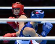 9 August 2012; Katie Taylor, Ireland, left, exchanges punches with Sofya Ochigava, Russia, during their women's light 60kg final contest. London 2012 Olympic Games, Boxing, South Arena 2, ExCeL Arena, Royal Victoria Dock, London, England. Picture credit: David Maher / SPORTSFILE