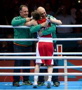 9 August 2012; Katie Taylor, Ireland, is congratulated by her father and coach Pete Taylor, right, and Team Ireland technical coach Zaur Antia after she was declared the winner over Sofya Ochigava, Russia, in their women's light 60kg final contest. London 2012 Olympic Games, Boxing, South Arena 2, ExCeL Arena, Royal Victoria Dock, London, England. Picture credit: Ray McManus / SPORTSFILE