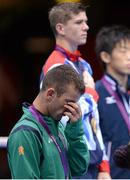 11 August 2012; Team Ireland's John Joe Nevin, men's bantam 56kg, looks disappointed during the playing of the gold medallists National Anthem. London 2012 Olympic Games, Boxing, South Arena 2, ExCeL Arena, Royal Victoria Dock, London, England. Picture credit: Brendan Moran / SPORTSFILE