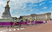 12 August 2012; Ireland's Mark Kenneally passes Buckingham Palace and the Queen Victoria memorial during the men's marathon where he finished in 57th place. London 2012 Olympic Games, Athletics, The Mall, Westminster, London, England. Picture credit: Brendan Moran / SPORTSFILE