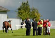 12 August 2012; Jockey Johnny Murtagh is checked by the medical staff after he was unseated by his mount Lottie Dod before the start of the Keeneland Phoenix Stakes. Curragh Racecourse, the Curragh, Co. Kildare. Picture credit: Matt Browne / SPORTSFILE