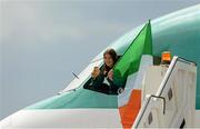 13 August 2012; Olympic champion Katie Taylor celebrates with her gold medal and the Irish Flag out of the cockpit of the St. Aidan, official Team Ireland jet, on their arrival home from the London 2012 Olympic Games. Dublin Airport, Dublin. Picture credit: Ray McManus / SPORTSFILE