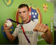 13 August 2012; Team Ireland's John Joe Nevin celebrates with his silver medal for boxing on their arrival home from the London 2012 Olympic Games. Dublin Airport, Dublin. Picture credit: Ray McManus / SPORTSFILE