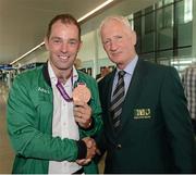 13 August 2012; Team Ireland's Cian O'Connor is congratulated by Chef d'Equipe Robert Splaine on his bronze medal for individual show jumping on his arrival home from the London 2012 Olympic Games. Dublin Airport, Dublin. Picture credit: Ray McManus / SPORTSFILE