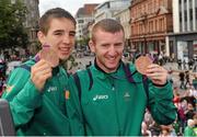 14 August 2012; Team Ireland boxers Paddy Barnes, right, and Michael Conlan celebrate with their bronze medals during an open top bus tour of Belfast, following their return home from the London 2012 Olympic Games. Belfast, Co. Antrim. Picture credit: Oliver McVeigh / SPORTSFILE
