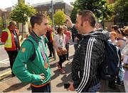 14 August 2012; Team Ireland boxers Michael Conlan talks with a supporter before an open top bus tour of Belfast, following their return home from the London 2012 Olympic Games. Belfast, Co. Antrim. Picture credit: Oliver McVeigh / SPORTSFILE