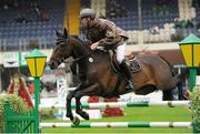 15 August 2012; Alexander Butler, Ireland, competing on Lowhill Ambassador, jumps the second during the Speed Stakes. Dublin Horse Show 2012, Main Arena, RDS, Ballsbridge, Dublin. Picture credit: Matt Browne / SPORTSFILE