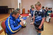 15 August 2012; Dylan Forster, age 10, From Straffan, Co. Kildare, has his rugby ball signed by Leinster's Heinke Van Der Merwe during the Garda RFC VW Leinster Rugby Summer Camp. Garda RFC, Westmanstown, Co. Dublin. Picture credit: Barry Cregg / SPORTSFILE