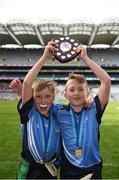 25 October 2017; Donabate Portrane Educate Together team-mates Levi Harley, left, and Ben Woolley celebrate with the shield after victory over St. Patrick's NS Glencullen during day 1 of the Allianz Cumann na mBunscol Finals at Croke Park in Dublin. Photo by Cody Glenn/Sportsfile