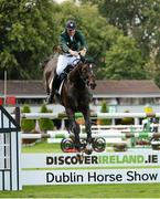 17 August 2012; Clem McMahon, Ireland, competing on Pacino, jumps the last for a double clear round to help his team win the FEI Nations Cup. Dublin Horse Show 2012, Main Arena, RDS, Ballsbridge, Dublin. Picture credit: Matt Browne / SPORTSFILE